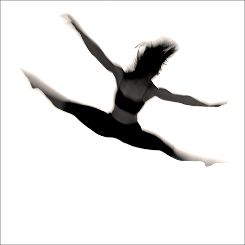 Silhouette of a dancer in mid-air, performing a split leap against a white background. The figures dynamic pose shows arms and legs extended, creating an impression of fluidity and grace.