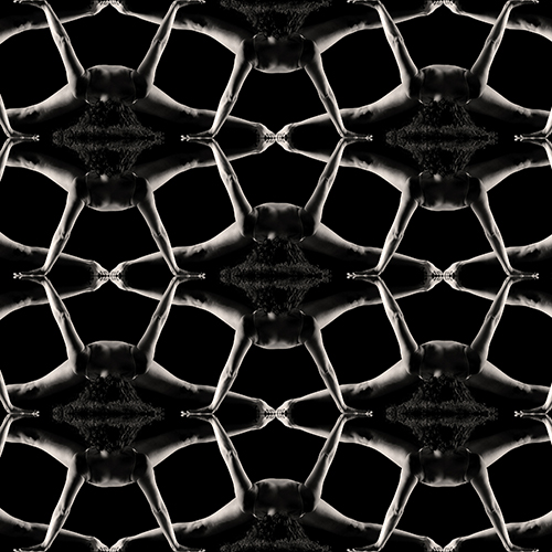 A geometric pattern of interconnected figures with outstretched arms and legs, creating a symmetrical, kaleidoscopic effect against a black background. The figures are arranged in a repetitive, lattice-like design.